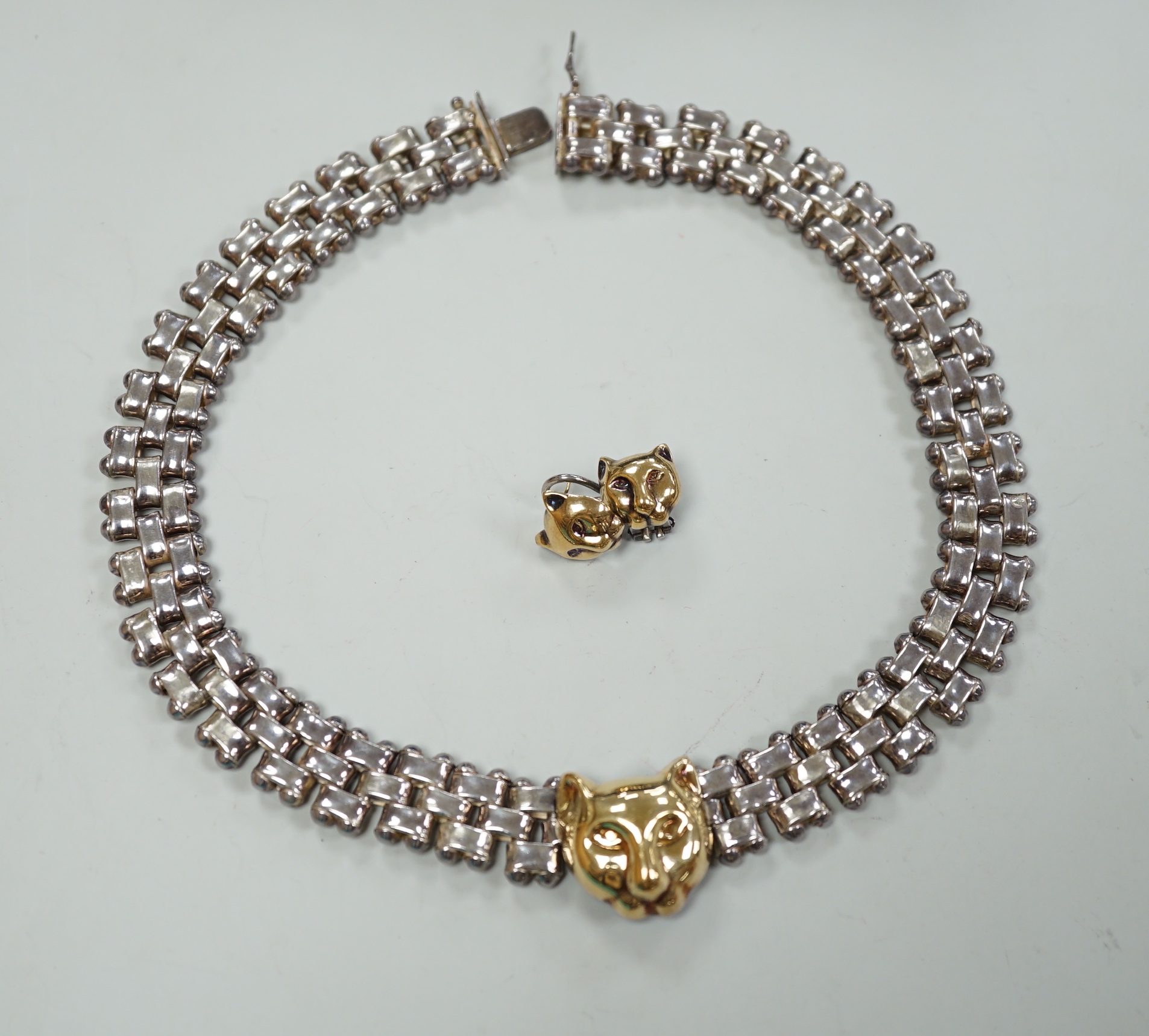 A modern Italian silver and 750 yellow metal necklace and pair of matching earrings, with leopard's head motif, necklace, 40cm.